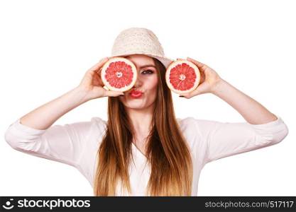Woman attractive long hair girl holding grapefruit fruits slices for her eyes on white. Smiling female recommending healthy food. Summer holidays happiness concept. Girl covering eyes with two halfs of grapefruit citrus fruit
