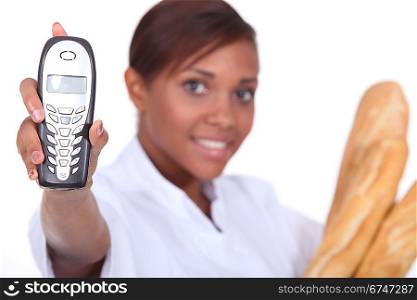 Woman baker showing phone