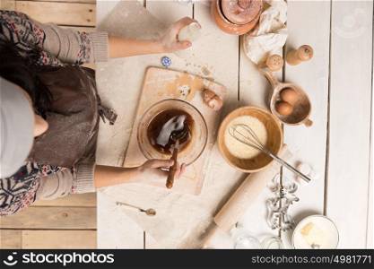 Woman baking Christmas cookies in her kitchen. Top view