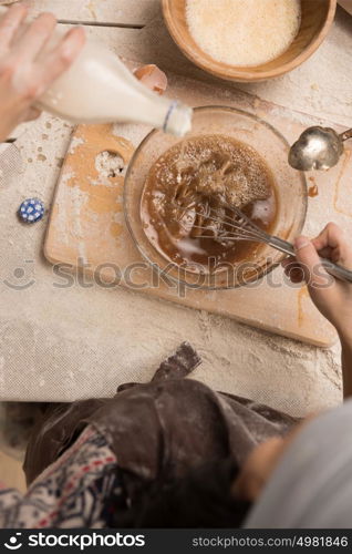 Woman baking Christmas cookies in her kitchen. Top view