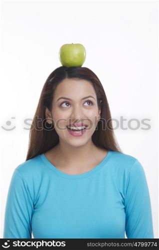 Woman balancing apple on head