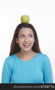 Woman balancing apple on head