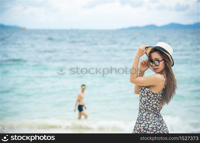 Woman bare foot walking on the summer beach. close up leg of young woman walking along wave of sea water and sand on the beach. Travel Concept.
