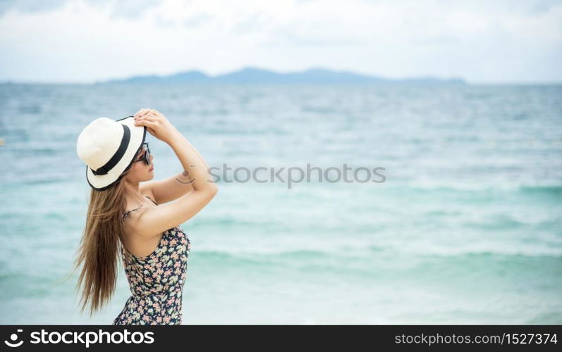 Woman bare foot walking on the summer beach. close up leg of young woman walking along wave of sea water and sand on the beach. Travel Concept.