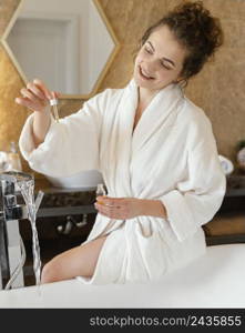 woman bath robe preparing bathtub 2