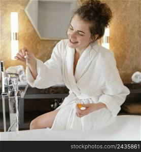woman bath robe preparing bathtub