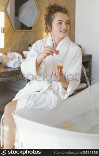 woman bath robe preparing bathtub 3