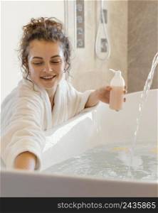woman bathrobe pouring soap bathtub 2