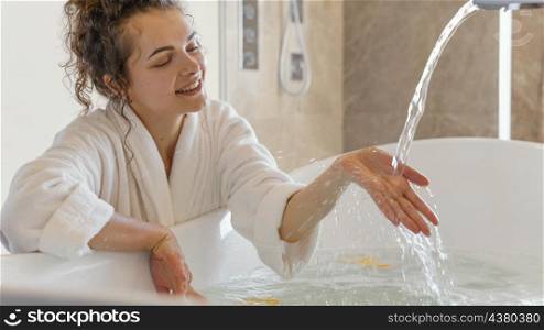 woman bathrobe with hand water