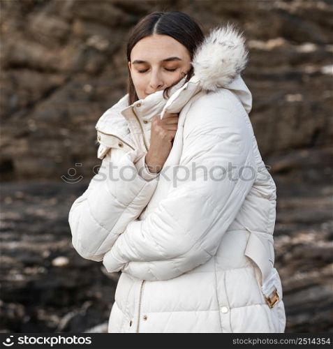 woman beach alone with winter jacket