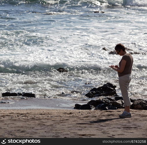 Woman beachcombing on Glass Beach in Kauai