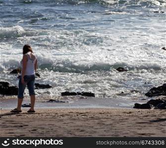 Woman beachcombing on Glass Beach in Kauai