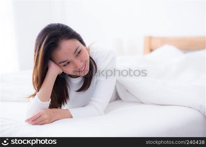 woman beautiful smiling woman portrait wake up early morning after sleeping and lying in bed.