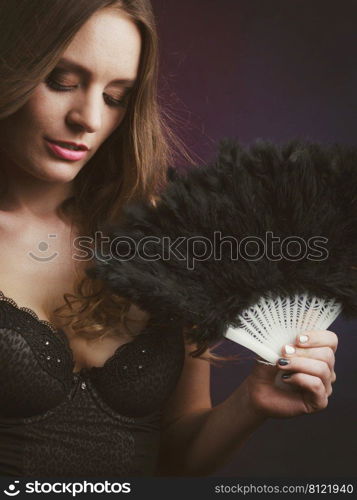 Woman beauty female face eyes makeup holding carnival feather fan in hand. Party new year celebration concept.. Woman holding carnival feather fan in hand.