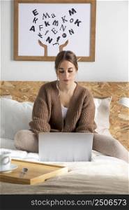 woman bed working laptop