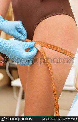 woman before procedures, doctor measuring her hip