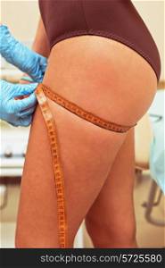 woman before procedures, doctor measuring her hip