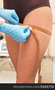 woman before procedures, doctor measuring her hip