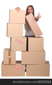 Woman behind a pile of cardboard boxes