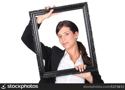 Woman behind black frame