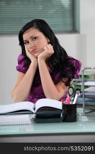 Woman behind her desk