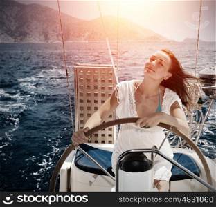 Woman behind the wheel yacht, enjoying sea nature and mountais landscape, active sailor girl, female driving luxury water transport, summertime concept