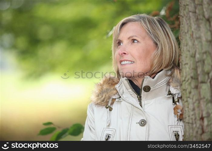 Woman behind tree