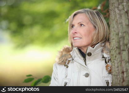 Woman behind tree