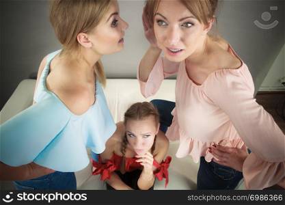 Woman being gossiped bullied by two female friends. Friendship difficulties, rivaly and envy problems.. Woman being gossiped by two