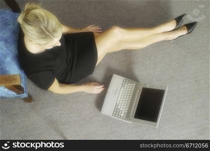 Woman beside laptop