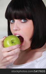 Woman biting apple