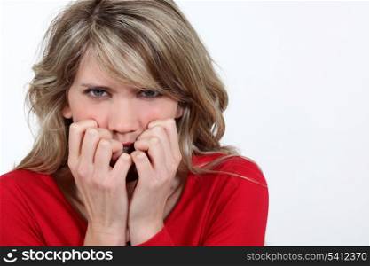 Woman biting her nails in fright