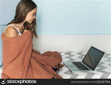 woman blanket home working laptop during pandemic