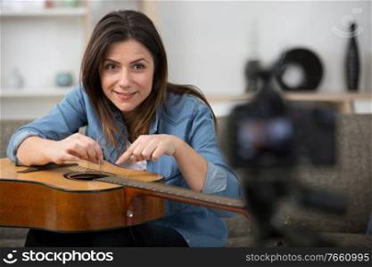 woman blogger with an acoustic guitar