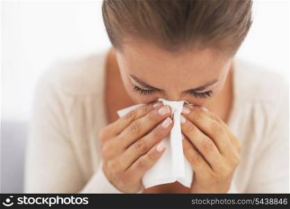 Woman blowing nose into handkerchief