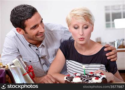 Woman blowing out a candle on her birthday