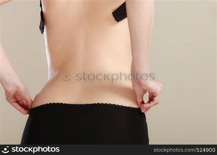 woman body in black cotton underwear back view. Closeup woman body in black underwear