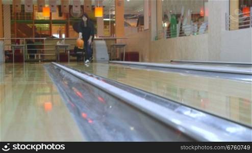 Woman bowler playing bowling in boutique center