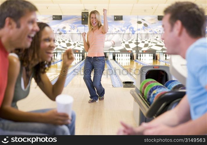 Woman bowling with friends