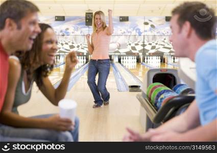 Woman bowling with friends