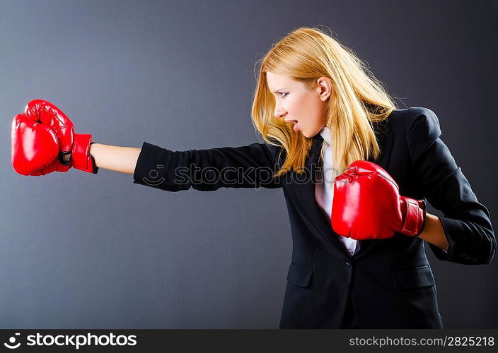 Woman boxer in dark room