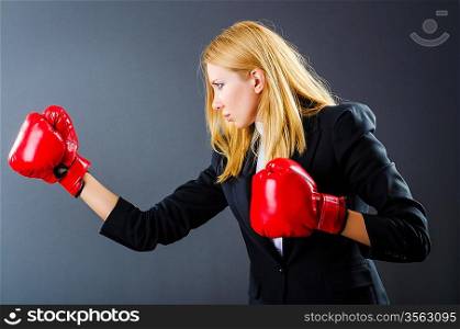 Woman boxer in dark room