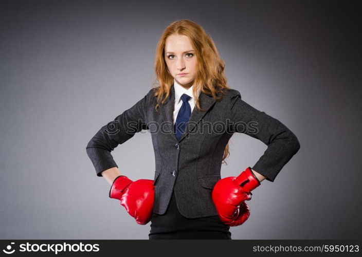 Woman boxer in dark room