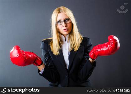 Woman boxer in dark room