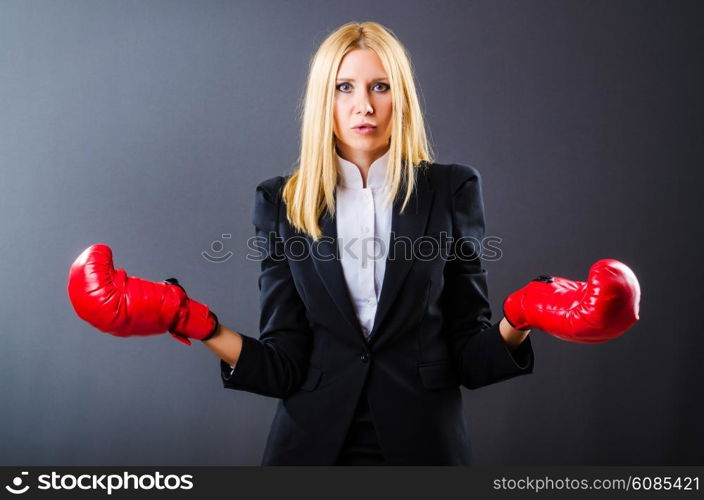 Woman boxer in dark room