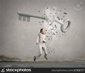 Woman break key. Angry businesswoman crashing stone key with punch