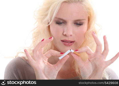 Woman breaking a cigarette