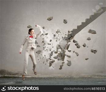 Woman breaking ladder. Young businesswoman crashing stone staircase representing success concept