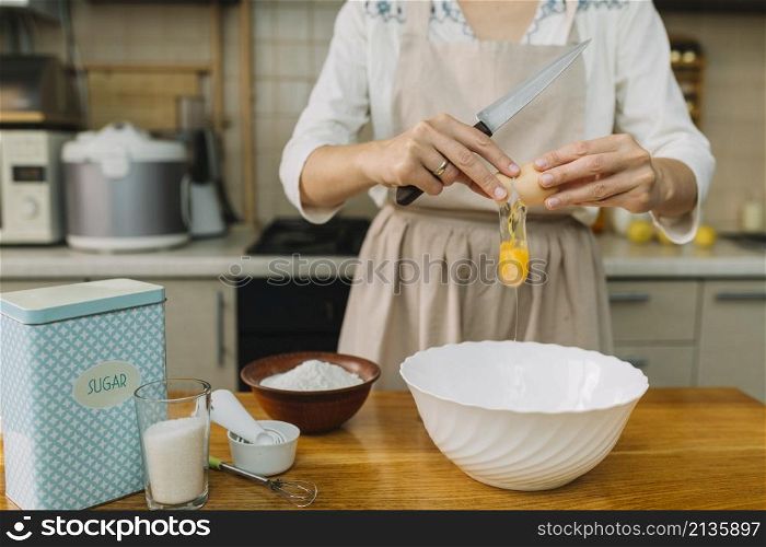 woman breaks egg making pie kitchen
