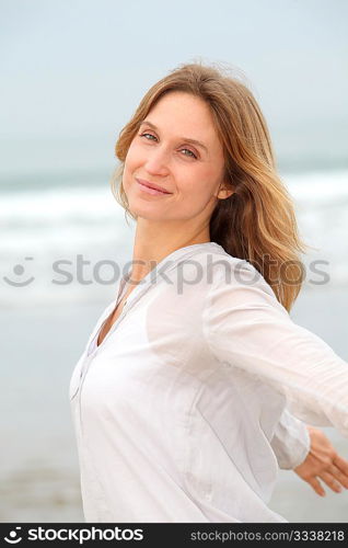 Woman breathing fresh air by the sea